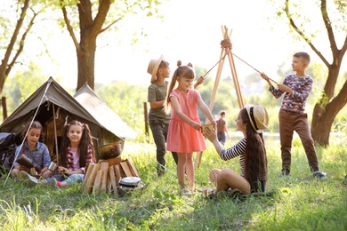 Little children near tent outdoors. Summer camp