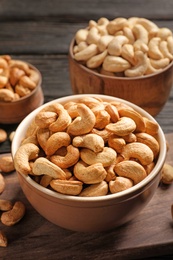 Bowl with cashew nuts on wooden table