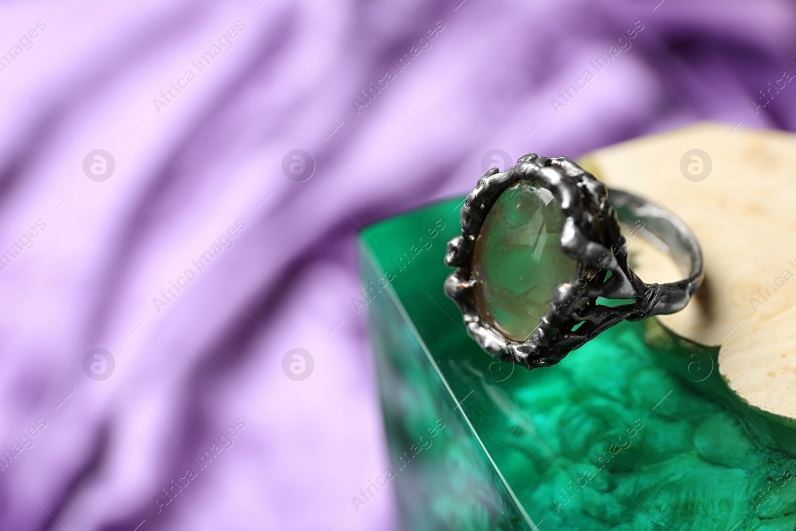 Photo of Beautiful silver ring with prehnite gemstone on textured surface. Space for text