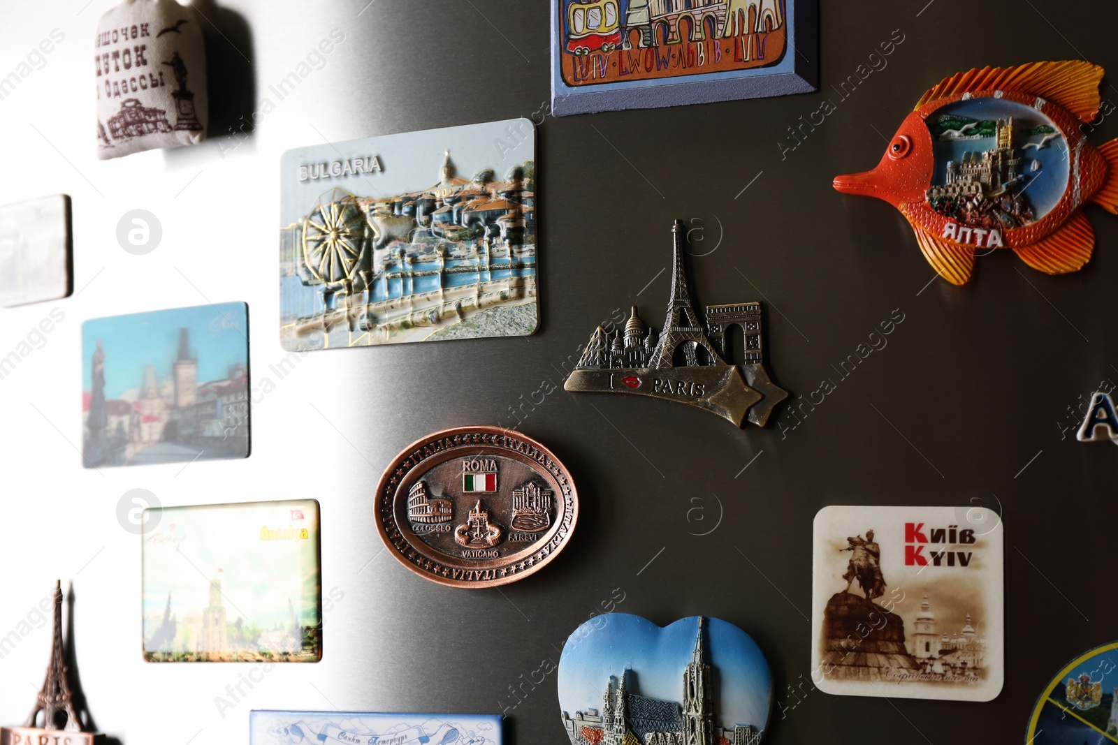 Photo of MYKOLAIV, UKRAINE - DECEMBER 25, 2018: Many different souvenir magnets on fridge door