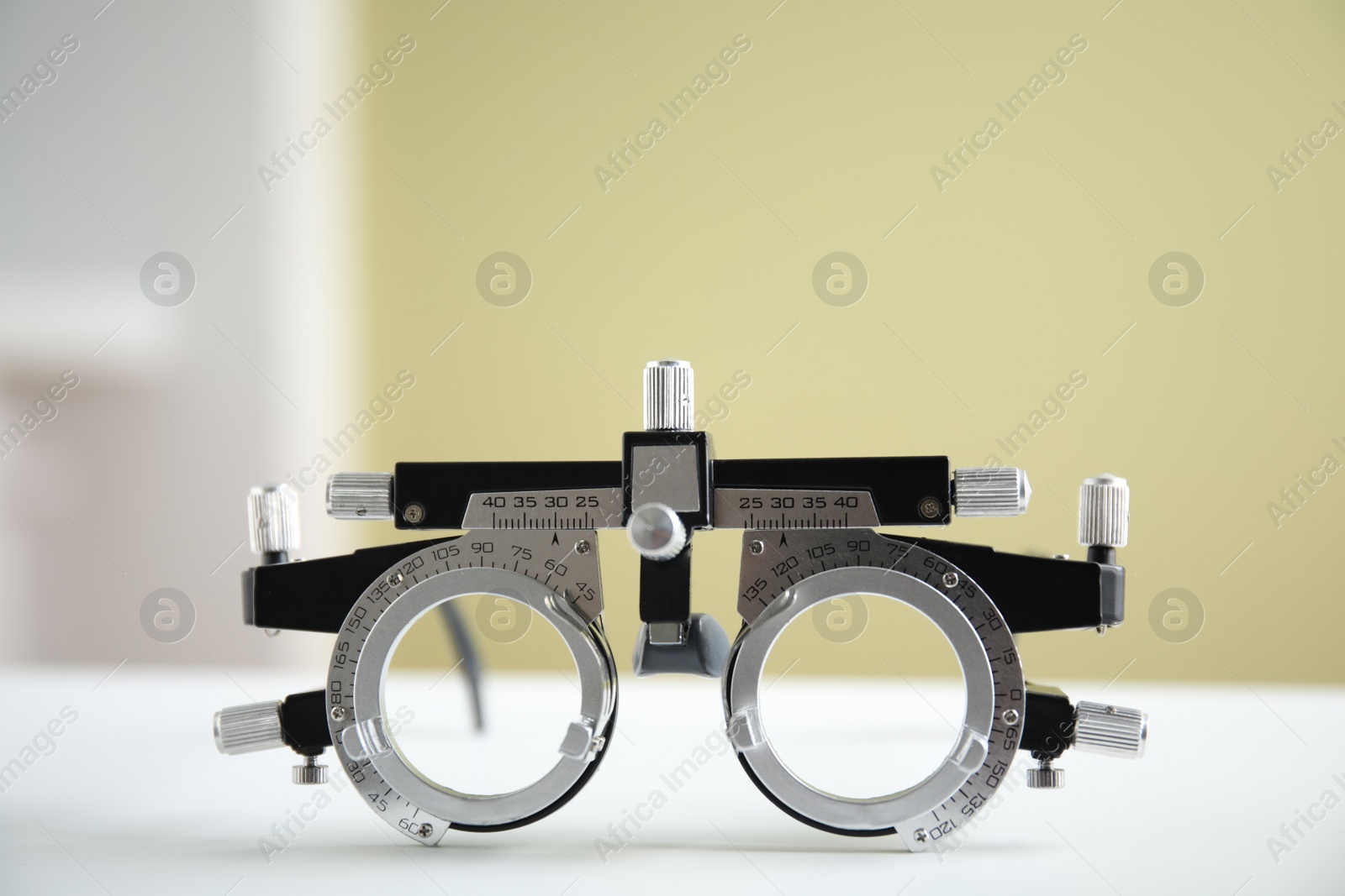 Photo of Trial frame on white table. Ophthalmologist tool