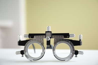 Photo of Trial frame on white table. Ophthalmologist tool