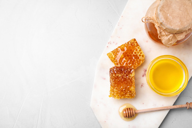 Photo of Tasty honey on light grey table, top view. Space for text