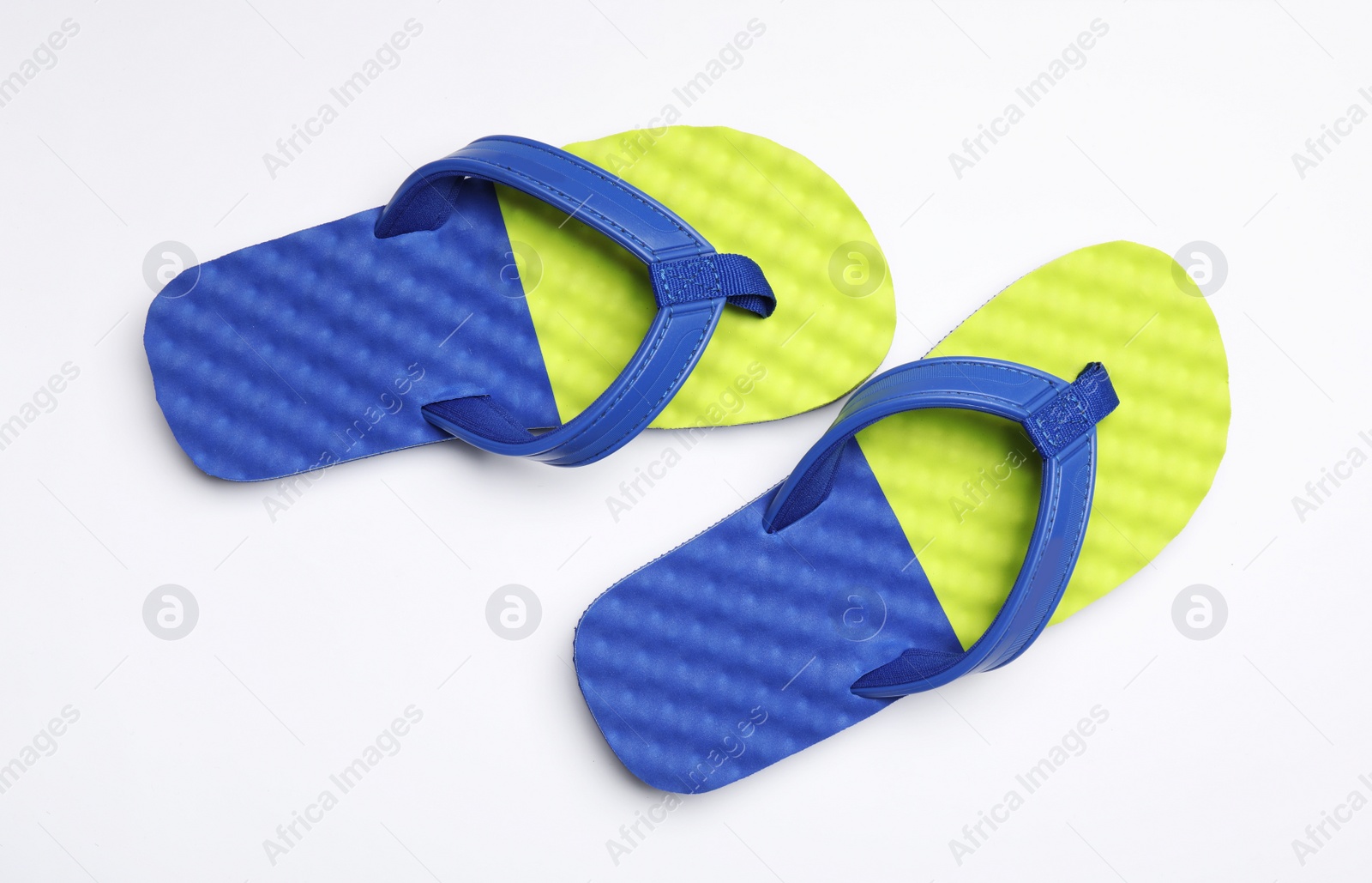 Photo of Pair of flip flops on white background, top view. Beach accessories