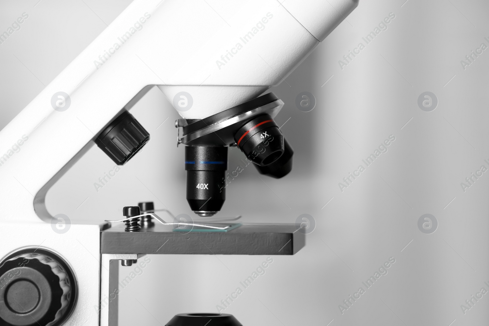 Photo of Modern medical microscope with glass slide on blurred background, closeup. Space for text