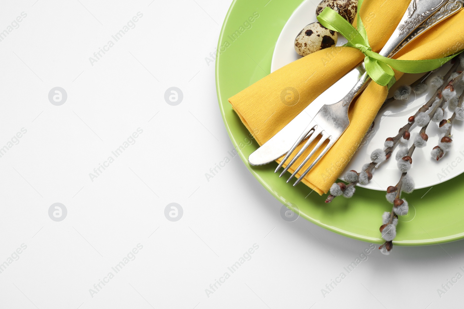 Photo of Festive Easter table setting with floral decor on white background, top view