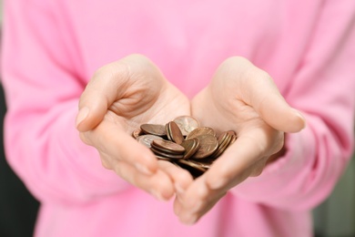 Photo of Woman holding pile of coins, closeup view