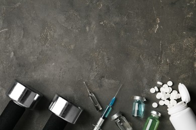 Different drugs, sports equipment and space for text on grey table, flat lay. Doping control