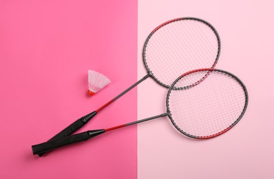 Photo of Rackets and shuttlecock on color background, flat lay. Badminton equipment