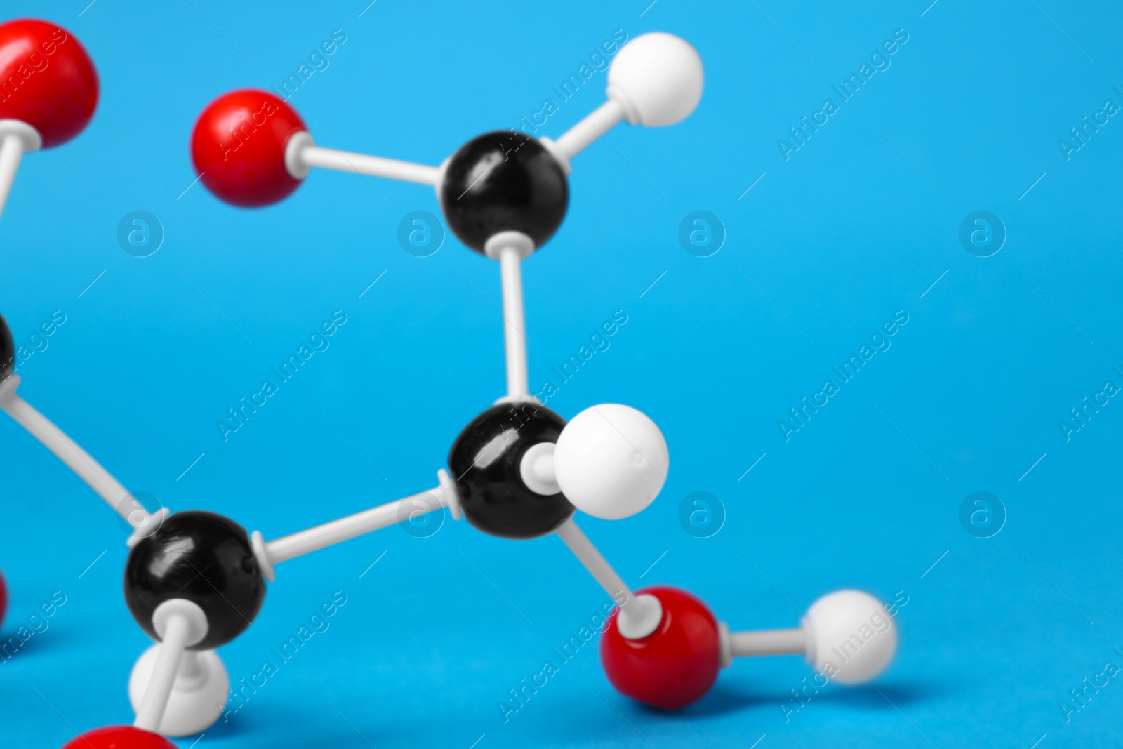 Photo of Molecule of glucose on light blue background, closeup and space for text. Chemical model