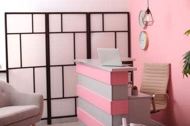 Photo of Reception desk in beauty salon. Stylish interior