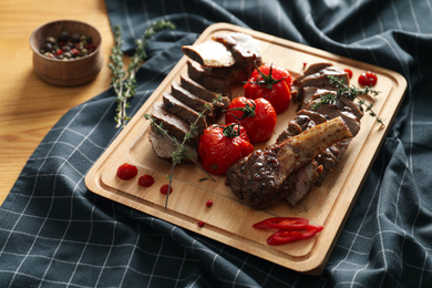 Delicious roasted ribs served on wooden table