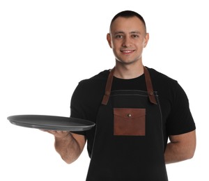 Photo of Portrait of happy young waiter with tray on white background