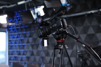 Photo of Modern video recording studio with professional camera