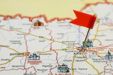 MYKOLAIV, UKRAINE - NOVEMBER 09, 2020: Kyiv city marked with push pin on map of Ukraine, closeup