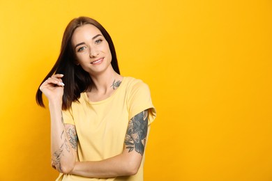 Portrait of pretty young woman with gorgeous chestnut hair on yellow background, space for text