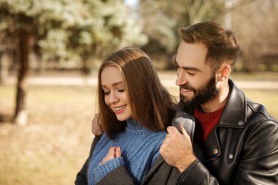 Portrait of cute young couple in park on sunny day