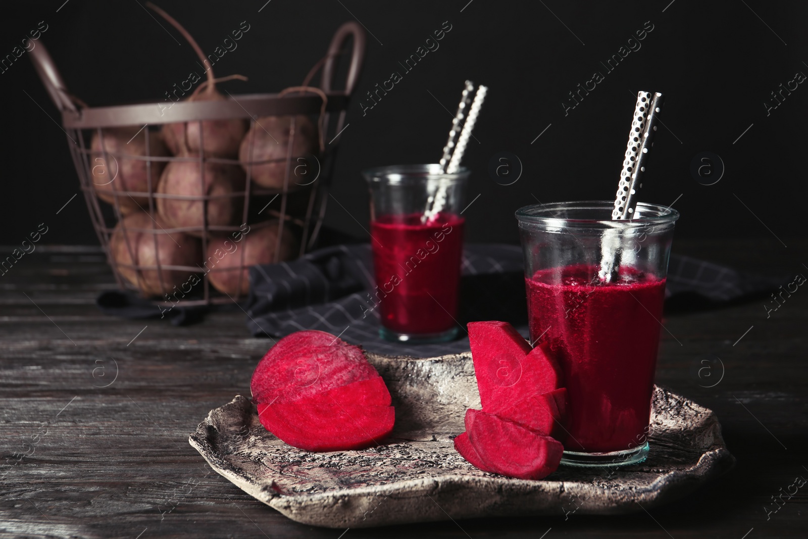 Photo of Plate with glass of beet smoothie on table