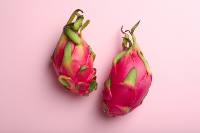 Photo of Delicious  pitahaya fruits on light pink background, flat lay