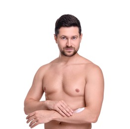 Handsome man applying sun protection cream onto arm against white background