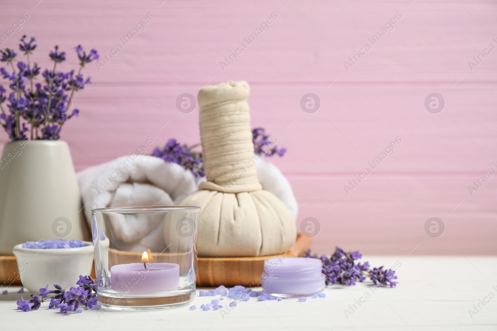 Photo of Cosmetic products and lavender flowers on white wooden table