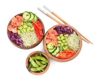 Delicious poke bowls with vegetables, fish and edamame beans on white background, top view