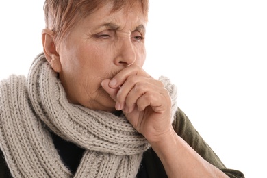 Elderly woman suffering from cough on white background