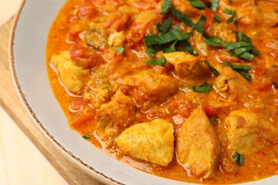 Photo of Delicious chicken curry with parsley on table, closeup