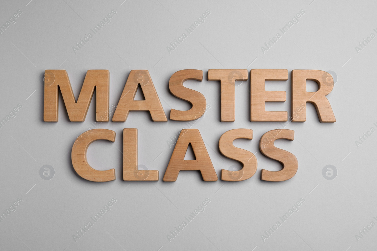 Photo of Words Master Class made of wooden letters on light grey background, flat lay