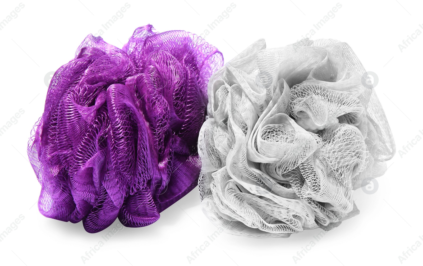 Photo of New shower puffs on white background. Personal hygiene