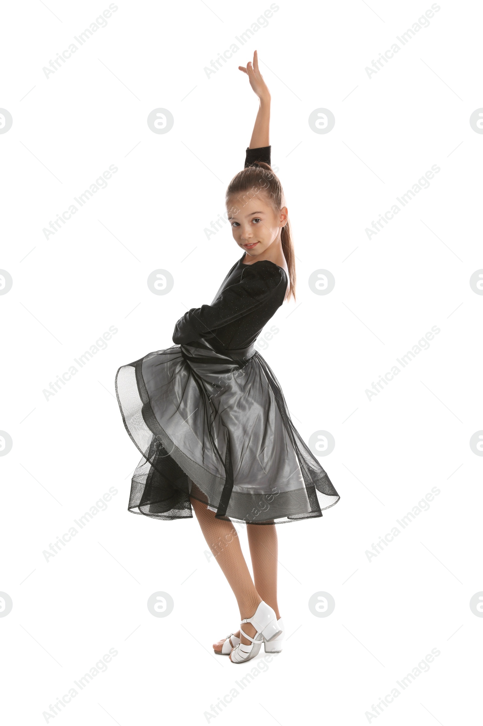 Photo of Beautifully dressed little girl dancing on white background