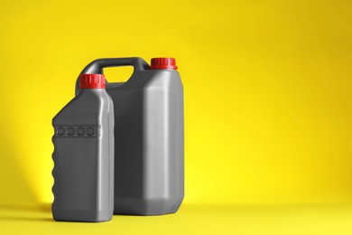 Photo of Canister and bottle of car products on yellow background. Space for text