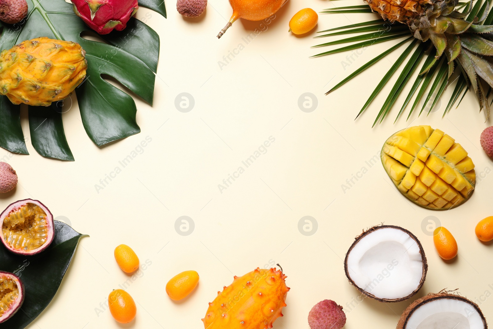 Photo of Frame of different exotic fruits on beige background, flat lay. Space for text