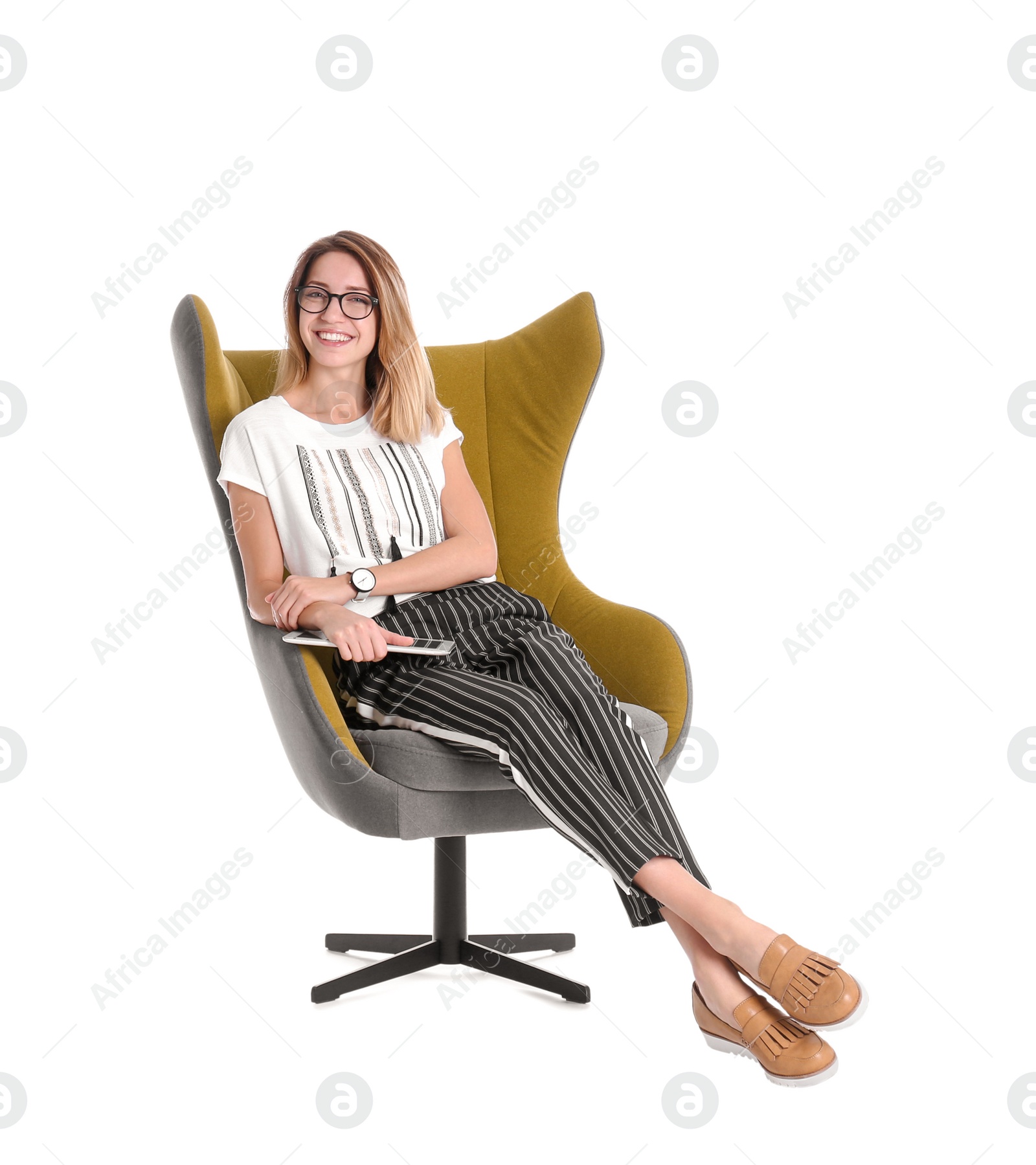 Photo of Young woman with tablet sitting in armchair on white background