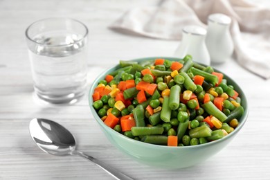 Photo of Mix of fresh vegetables served on white wooden table