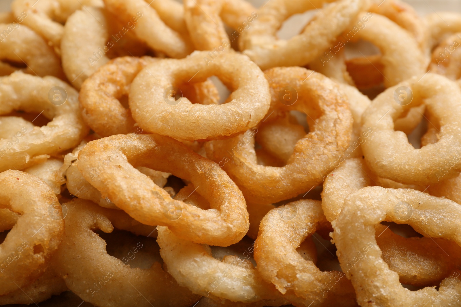 Photo of Freshly cooked onion rings as background