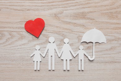 Paper family cutout and red heart on white wooden table, flat lay. Insurance concept