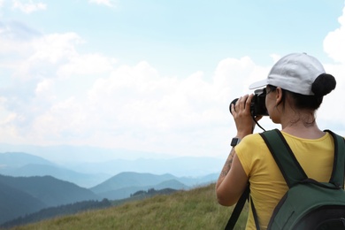 Photo of Professional nature photographer taking pictures in mountains. Space for text