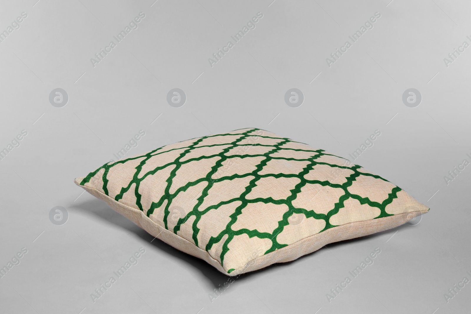 Photo of Single stylish decorative pillow on light background