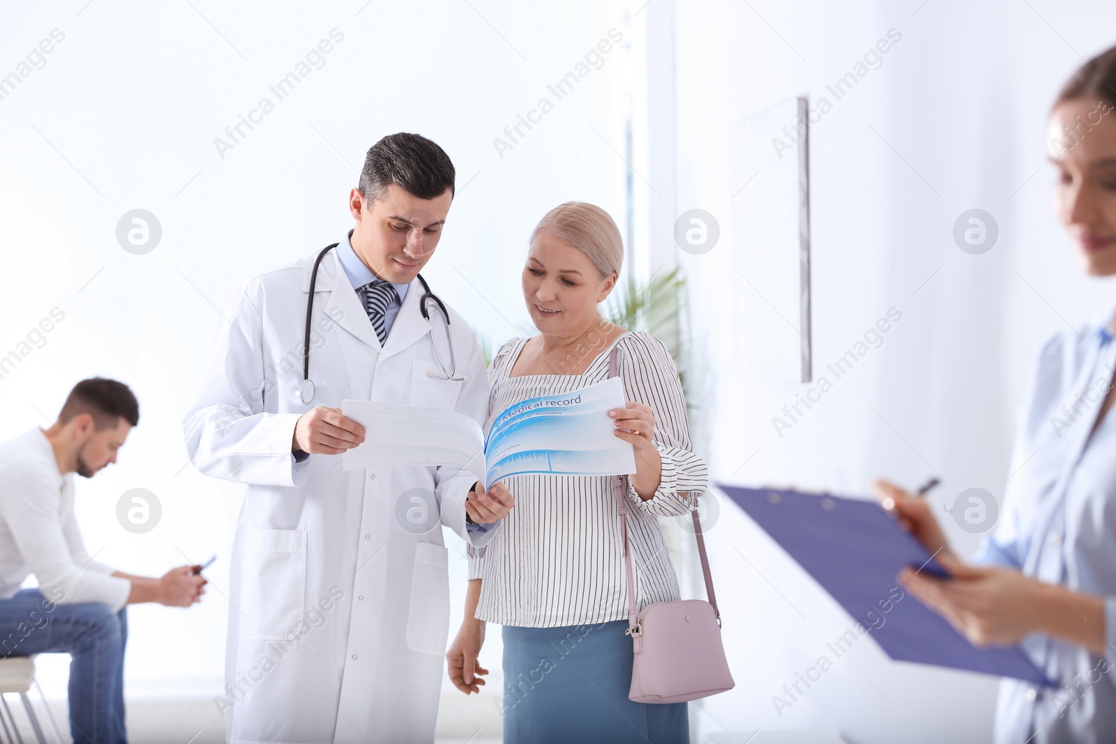 Photo of Doctor talking with patient in hospital hall