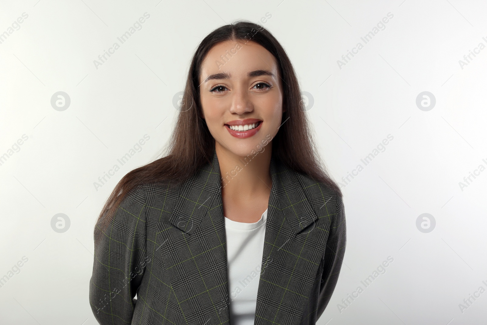 Photo of Portrait of happy young woman in stylish jacket on white background