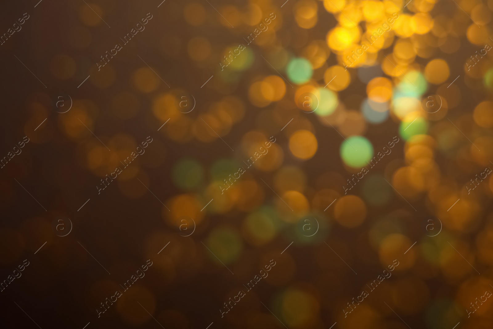 Photo of Blurred view of shiny lights on dark background. Bokeh effect