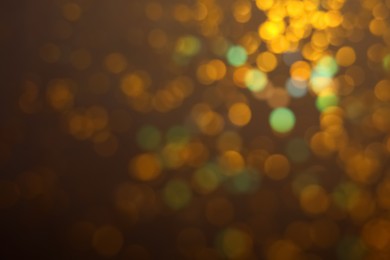 Photo of Blurred view of shiny lights on dark background. Bokeh effect