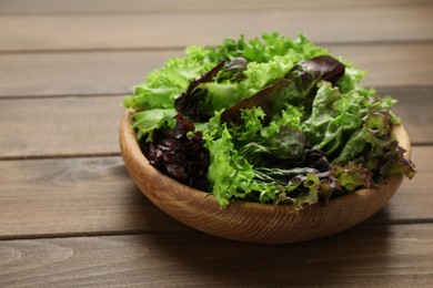Photo of Different sorts of lettuce on wooden table