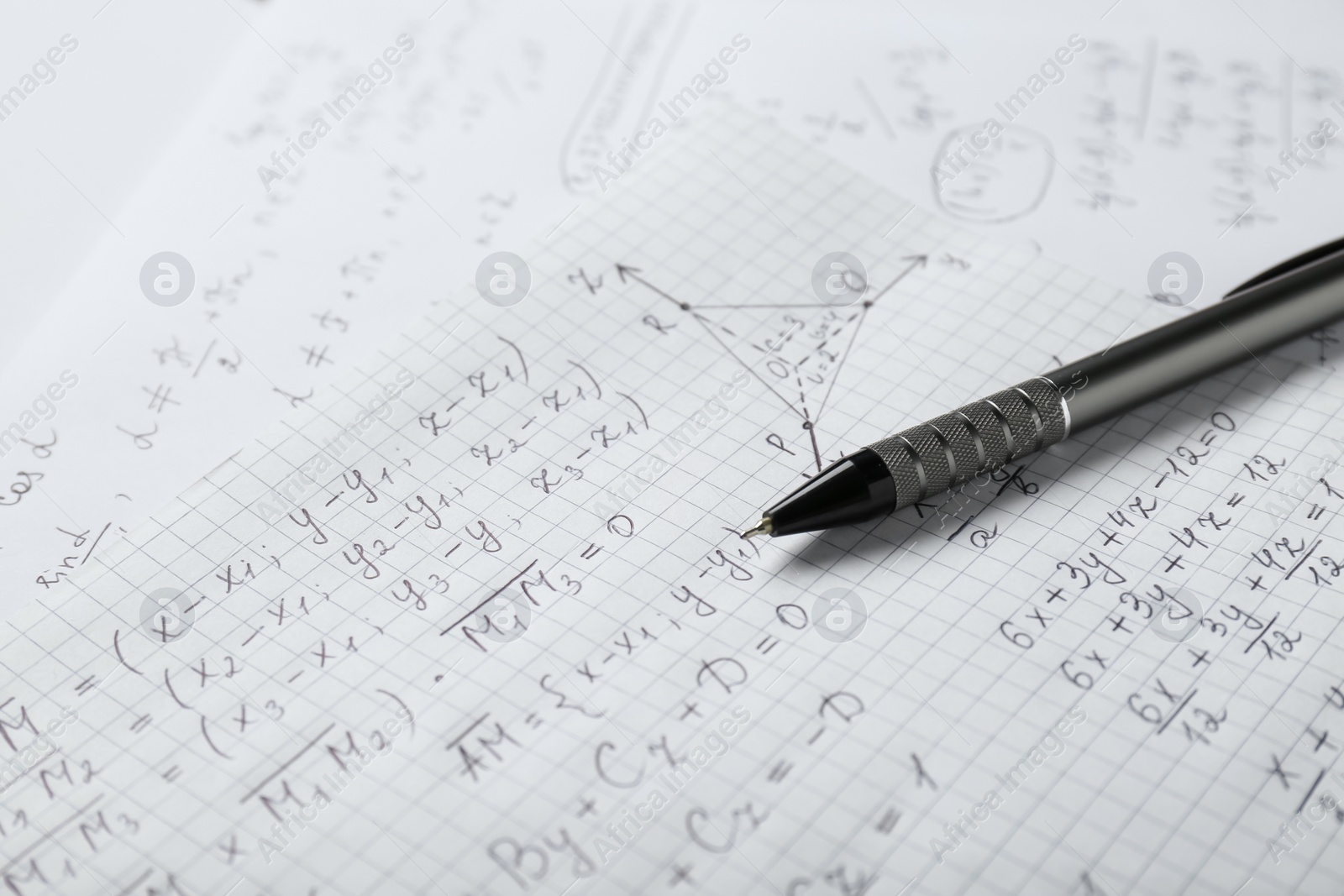 Photo of Sheets of paper with different mathematical formulas and pen, closeup