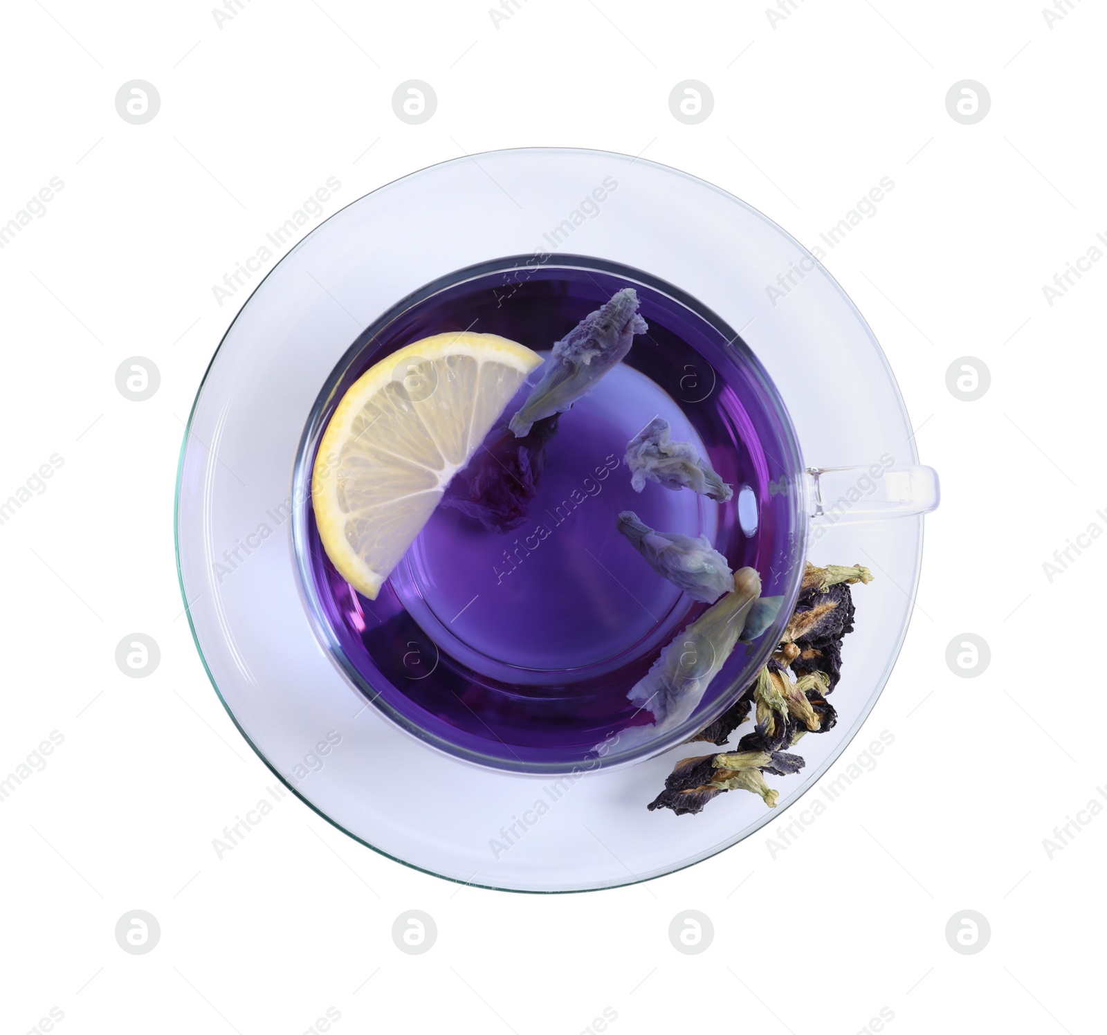 Photo of Glass cup of organic blue Anchan with lemon on white background, top view. Herbal tea