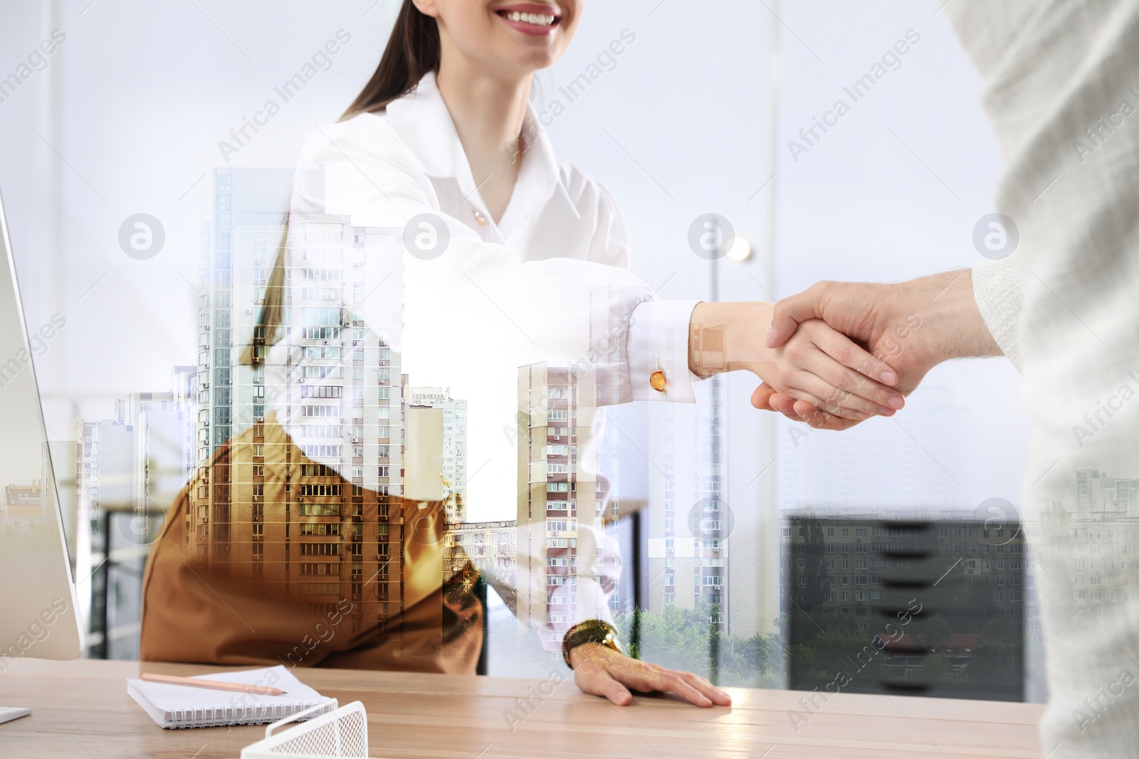 Image of Deal or partnership concept. Double exposure with cityscape and photo of businesspeople shaking hands