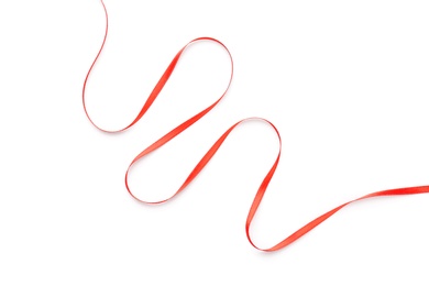 Photo of Simple red ribbon on white background, top view