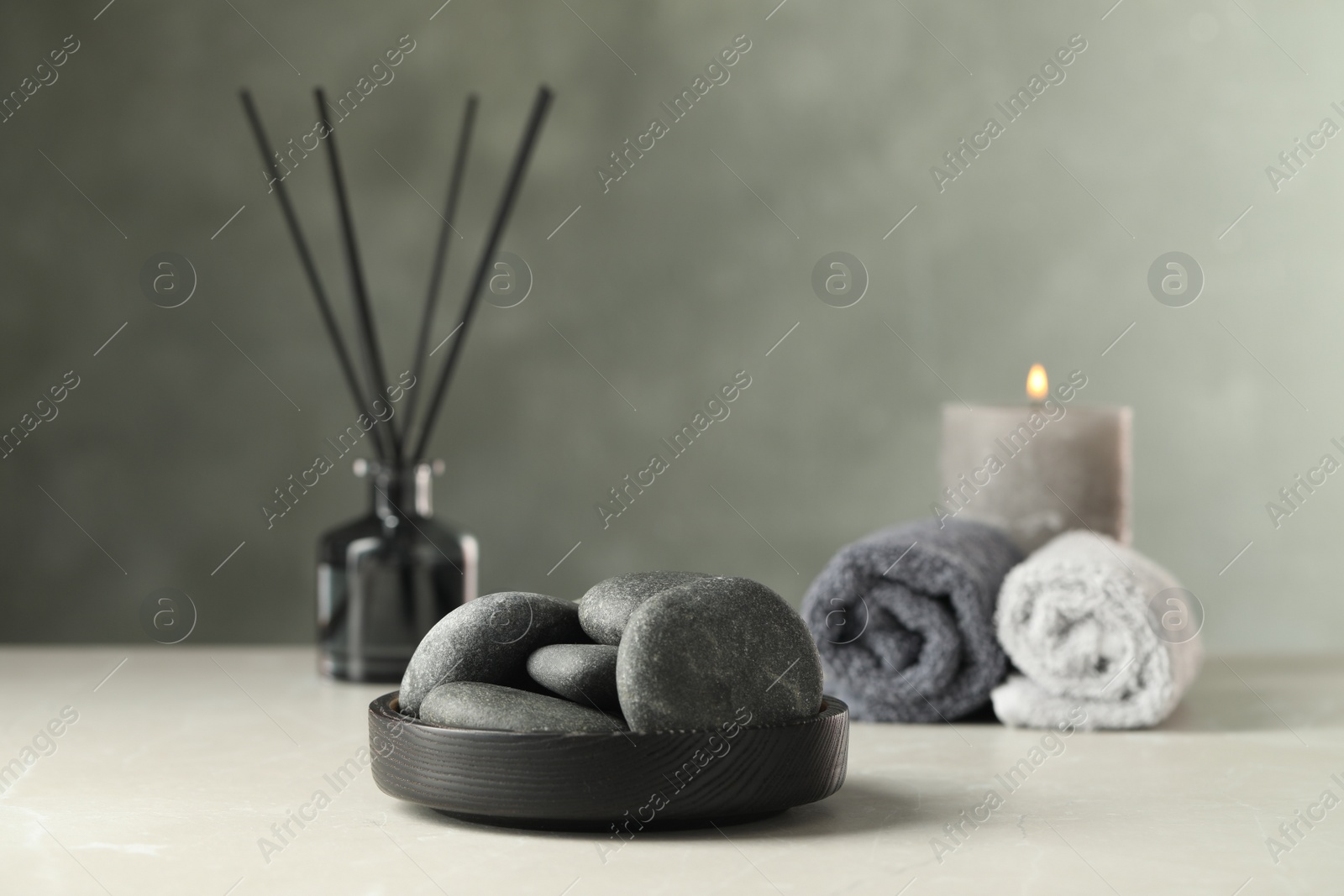 Photo of Spa stones in black tray on light marble table