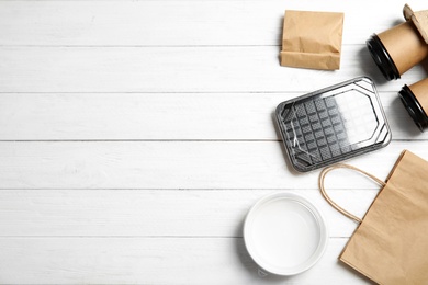 Different containers for mock up design on wooden background, flat lay. Food delivery service